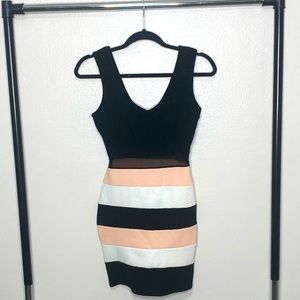 Black and striped fitted dress with a little mesh cutout. In size small.